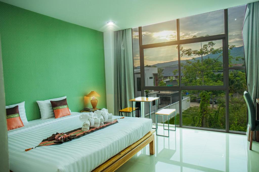 Postel nebo postele na pokoji v ubytování Km Hotel Chiang Mai