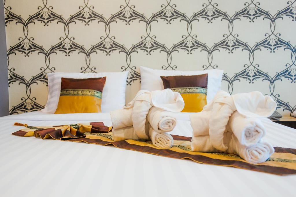 Postel nebo postele na pokoji v ubytování Km Hotel Chiang Mai
