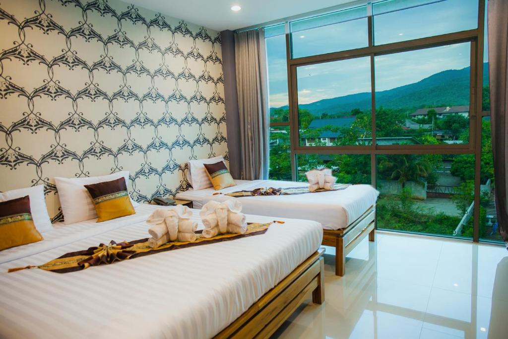 Postel nebo postele na pokoji v ubytování Km Hotel Chiang Mai