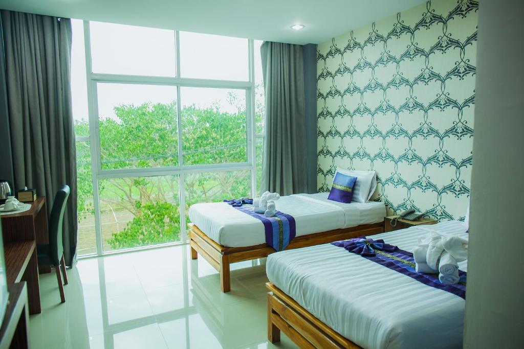 Postel nebo postele na pokoji v ubytování Km Hotel Chiang Mai