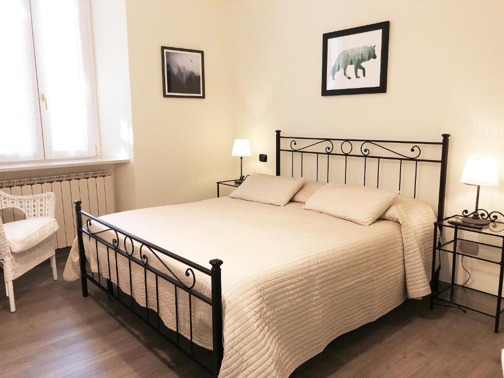 a bedroom with a large bed and a chair at C'era Un Lago in Avezzano