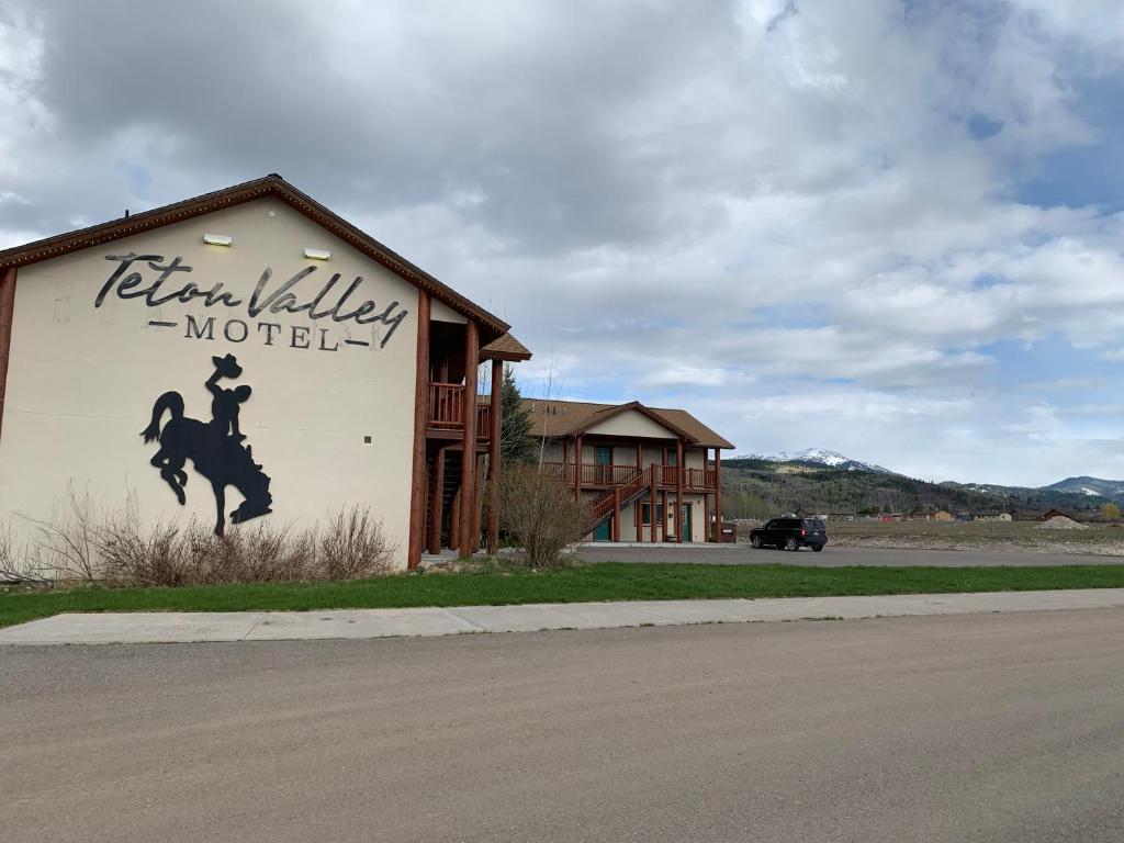 a sign on the side of a building with a horse on it at Teton Valley Motel in Victor