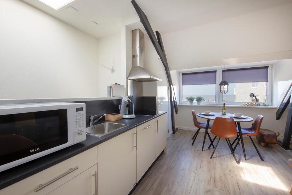 Cuisine ou kitchenette dans l'établissement Seapoint - Sea view
