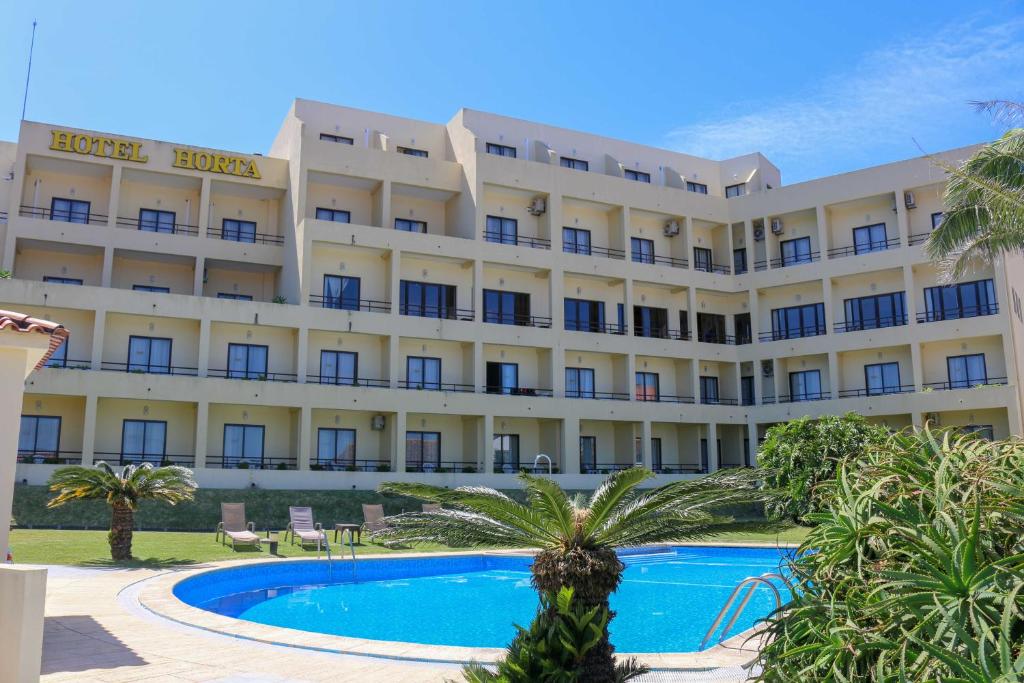 a hotel with a pool in front of it at Hotel Horta in Horta
