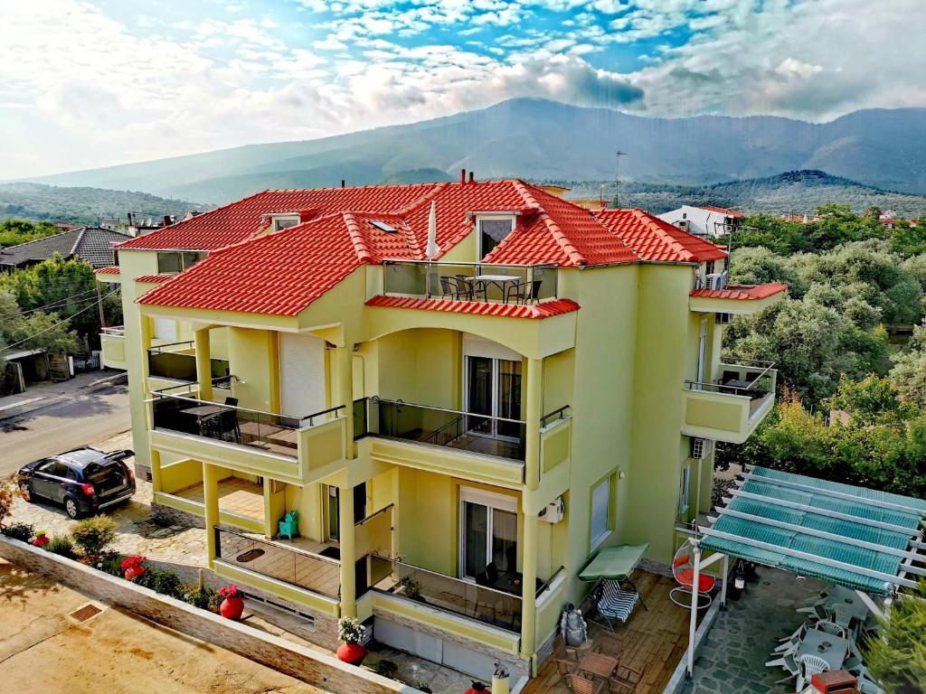 an image of a house with a red roof at Apartments Kidonis in Limenaria