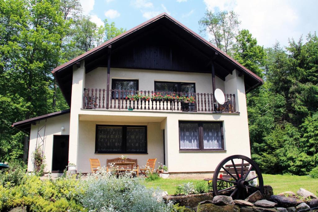 a house with a balcony and a wheel at Spacious house at the gate of Giant Mountains in Víchová nad Jizerou