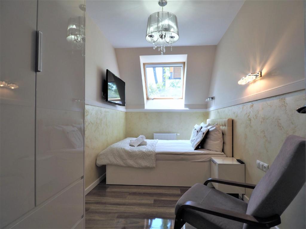 Televízia a/alebo spoločenská miestnosť v ubytovaní VIP Apartamenty Cristal