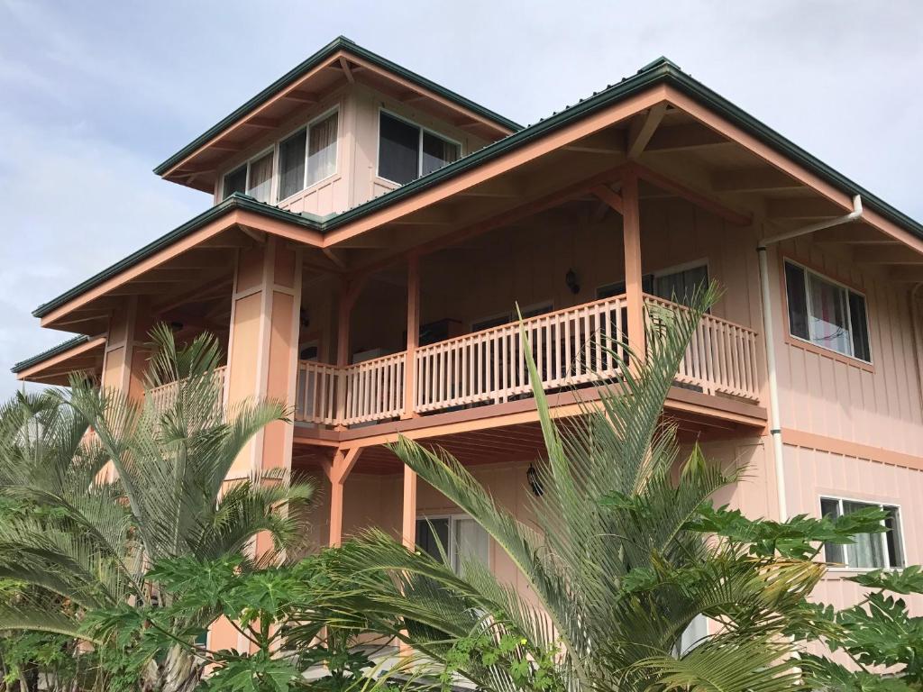 a large house with a wrap around balcony at Coconut Palms Vacation Rental near lava fields and beaches in Kehena