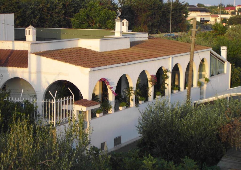 a white building with arches and a roof at Villa Nicolaus in Bari