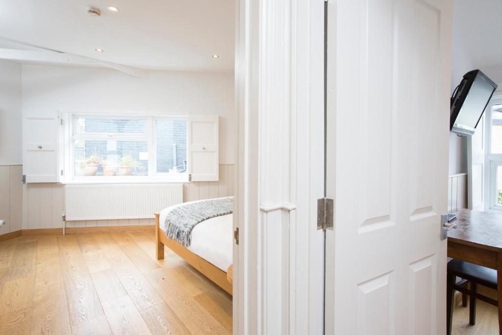 a bedroom with a bed and a desk and a window at Hotel Continental in Whitstable
