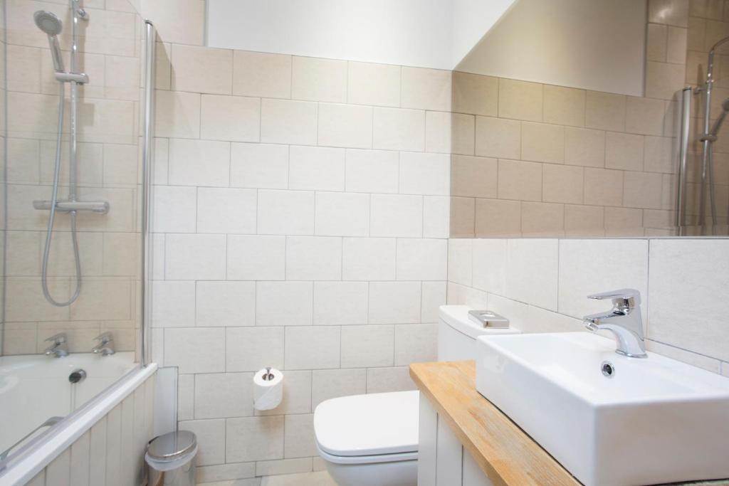 a bathroom with a sink and a toilet and a shower at Hotel Continental in Whitstable