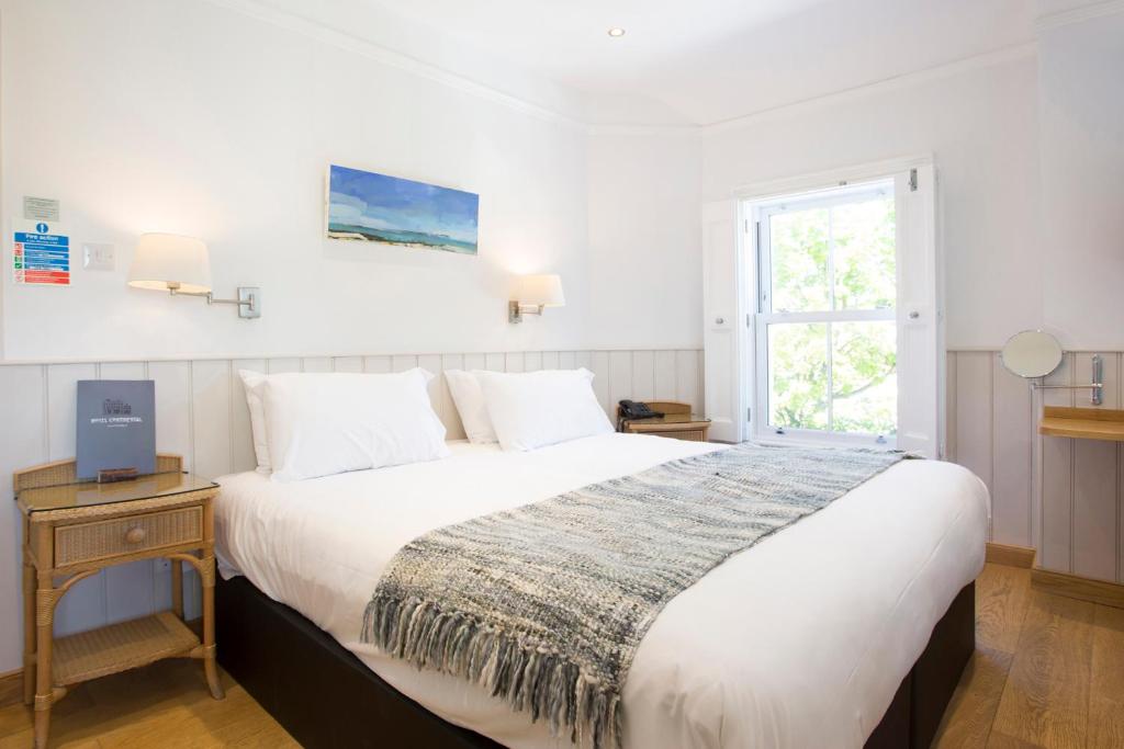 a bedroom with a large bed and a window at Hotel Continental in Whitstable