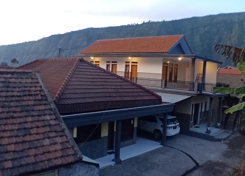 a house with a car parked in front of it at Holiday Home Anggun Bromo in Bromo