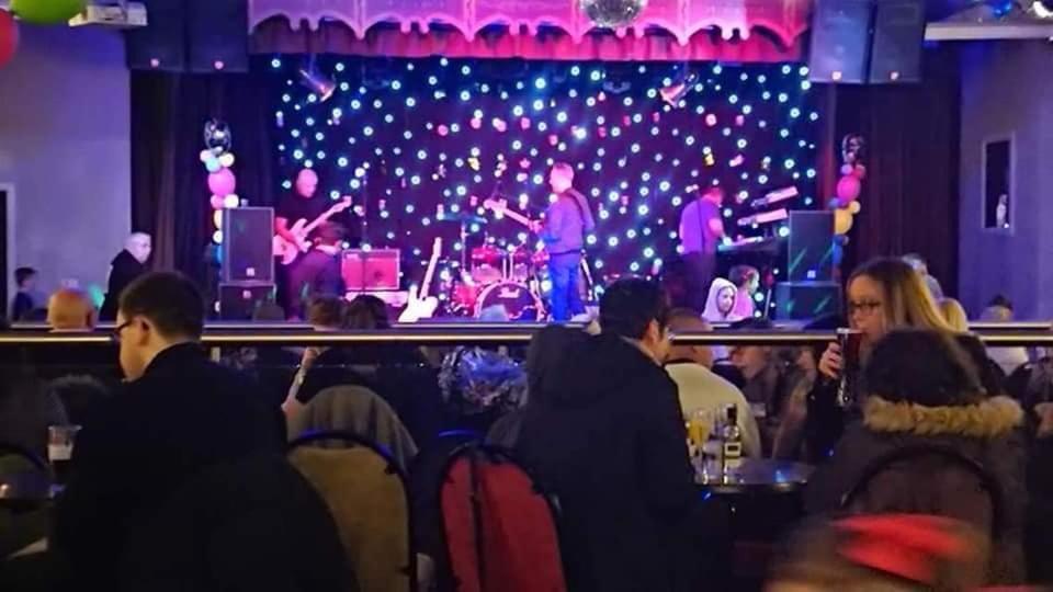 a group of people watching a band on a stage at Private Caravan on Golden Sands Holiday Park, North Wales in Foryd