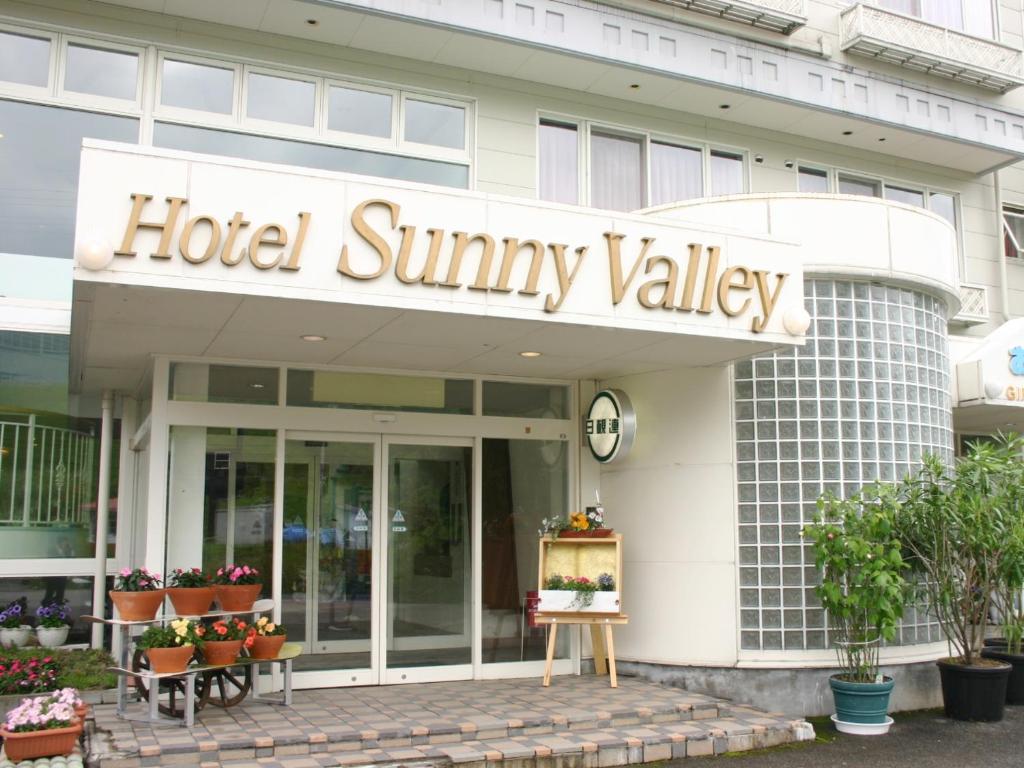 a hotel summaryvalley sign on the front of a building at Hotel Sunny Valley in Otari