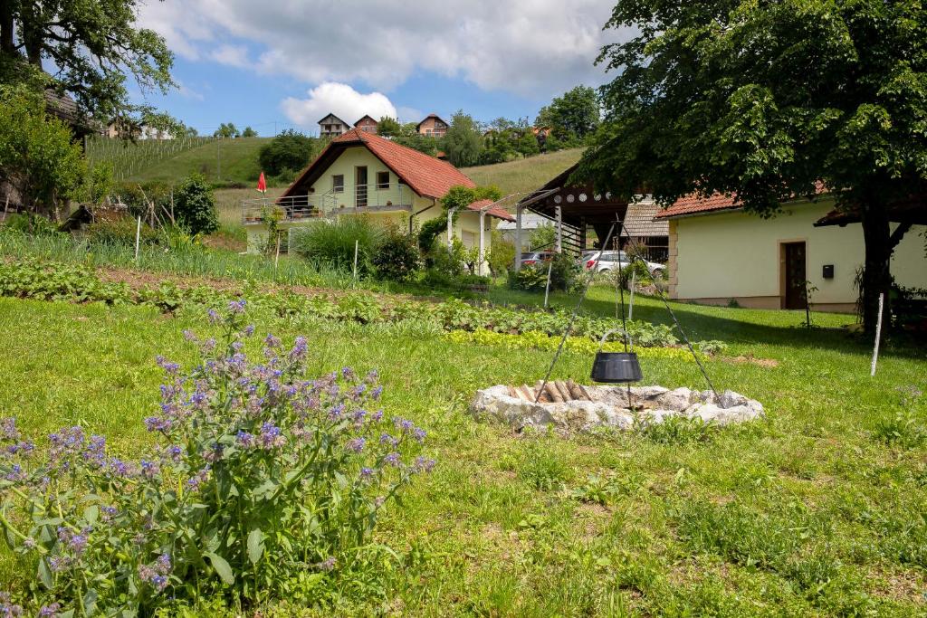 a garden with a bell in the middle of a yard at Domačija Vesel in Trebnje