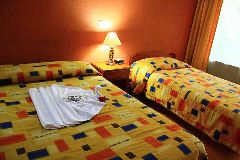 Postel nebo postele na pokoji v ubytování Hotel Guadalupe