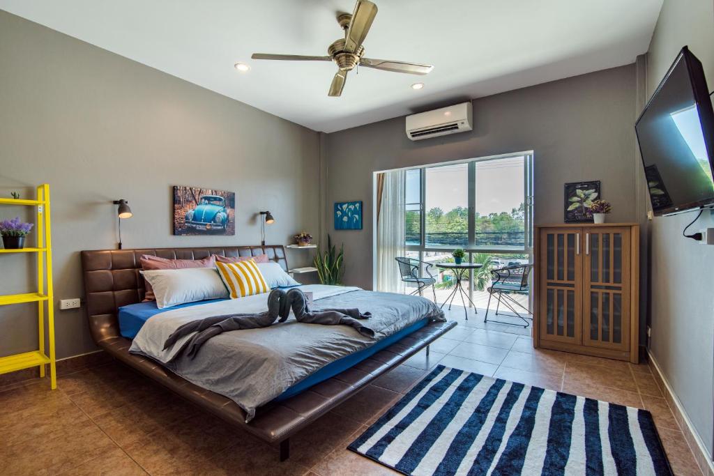 a bedroom with a bed with a dog laying on it at Super nice townhouse in city center, 10 minutes walk to beach, night market ... in Hua Hin