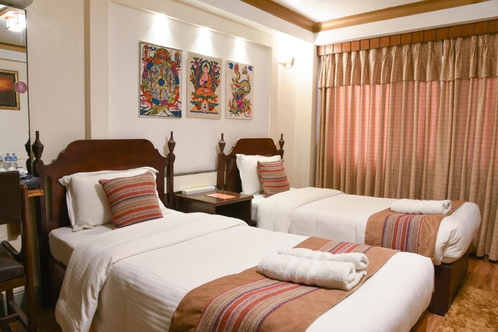 Postel nebo postele na pokoji v ubytování Nepal Pavilion Inn