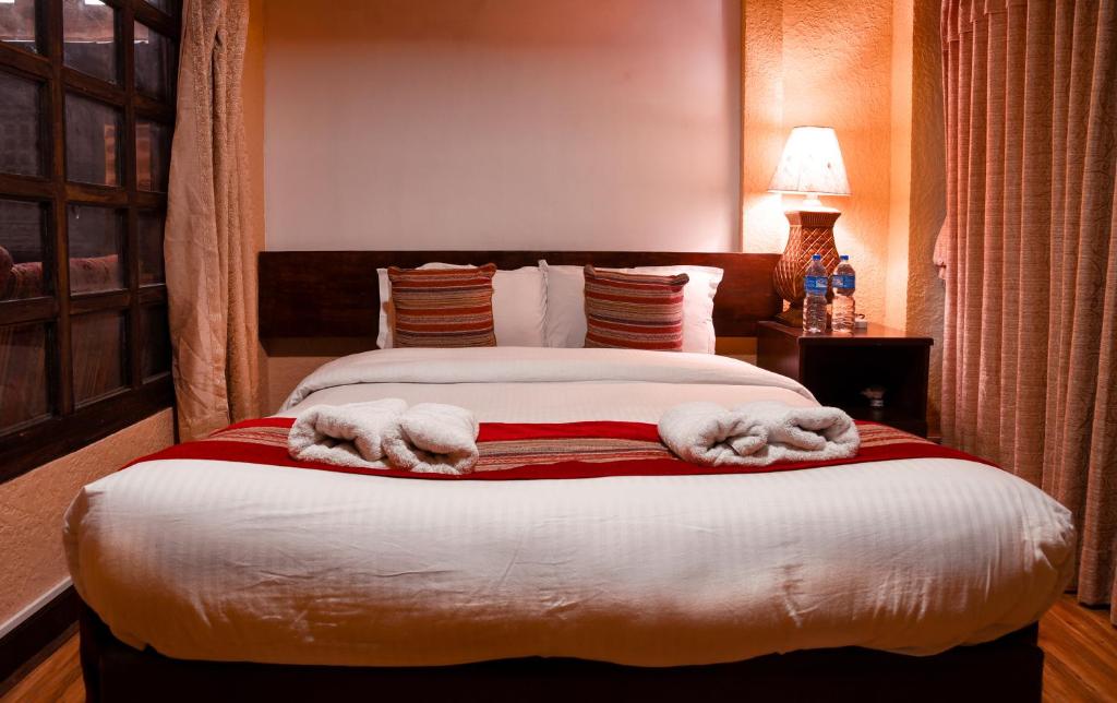 Postel nebo postele na pokoji v ubytování Nepal Pavilion Inn