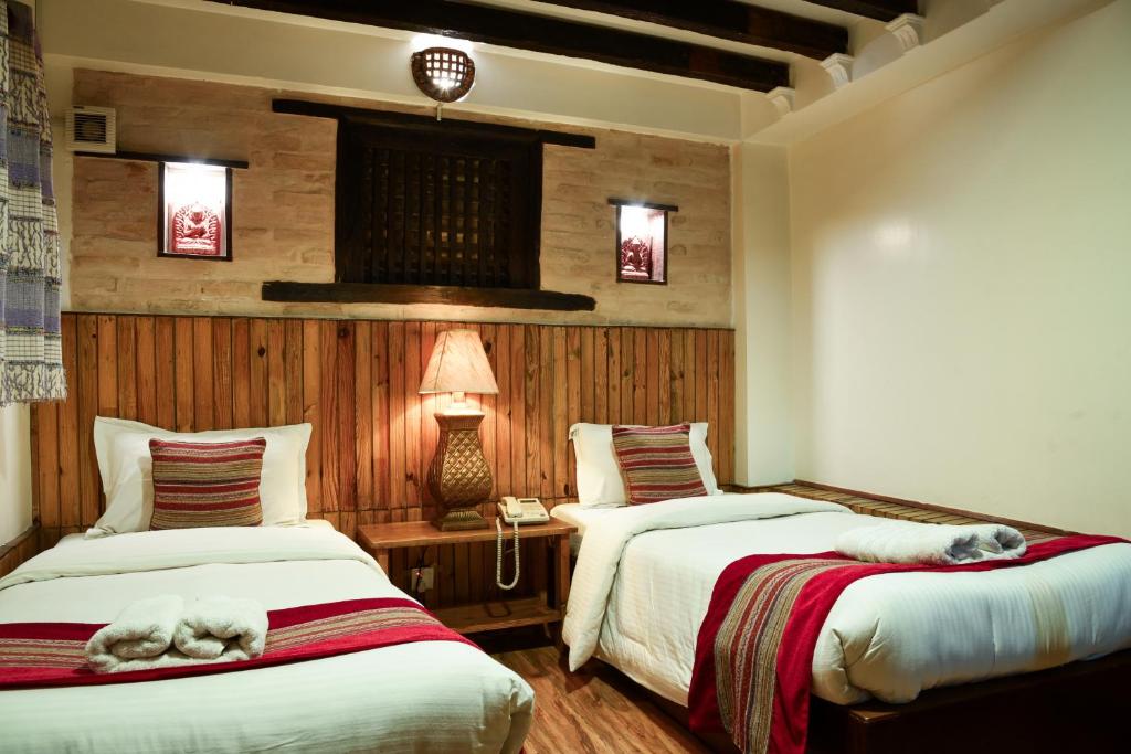 Postel nebo postele na pokoji v ubytování Nepal Pavilion Inn