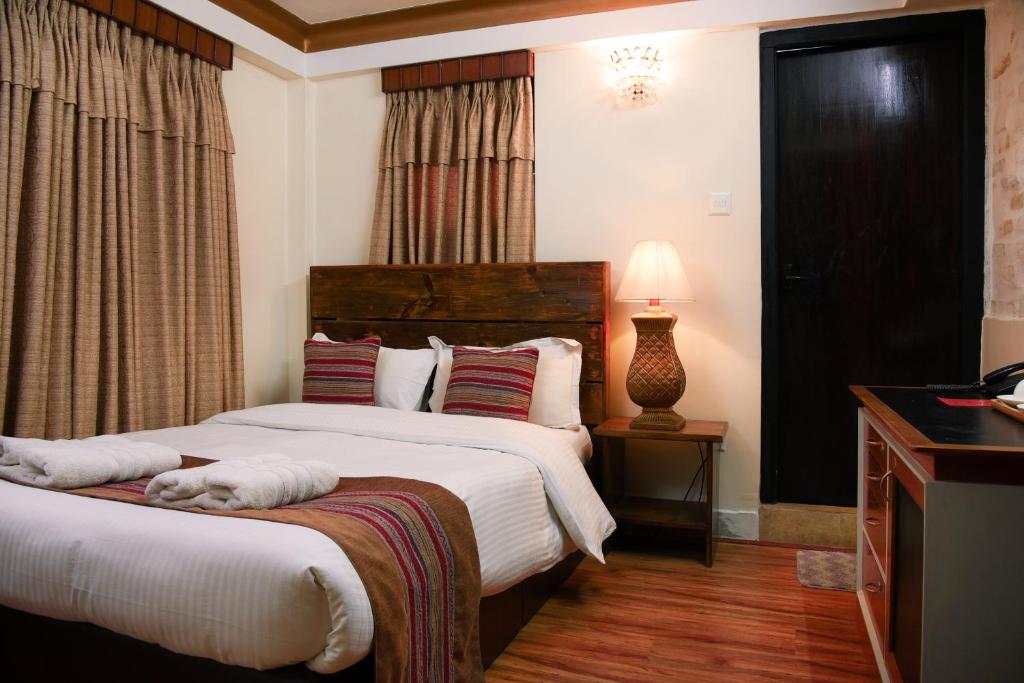 Postel nebo postele na pokoji v ubytování Nepal Pavilion Inn