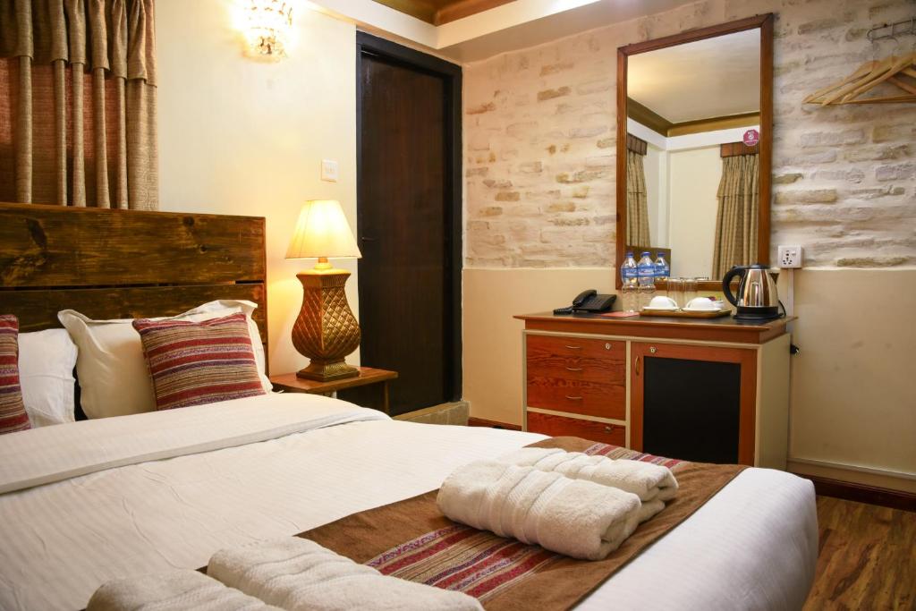 Postel nebo postele na pokoji v ubytování Nepal Pavilion Inn
