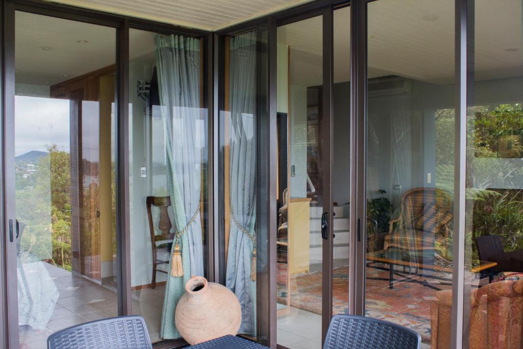 a glass house with a vase sitting on a patio at Titore Lodge in Russell