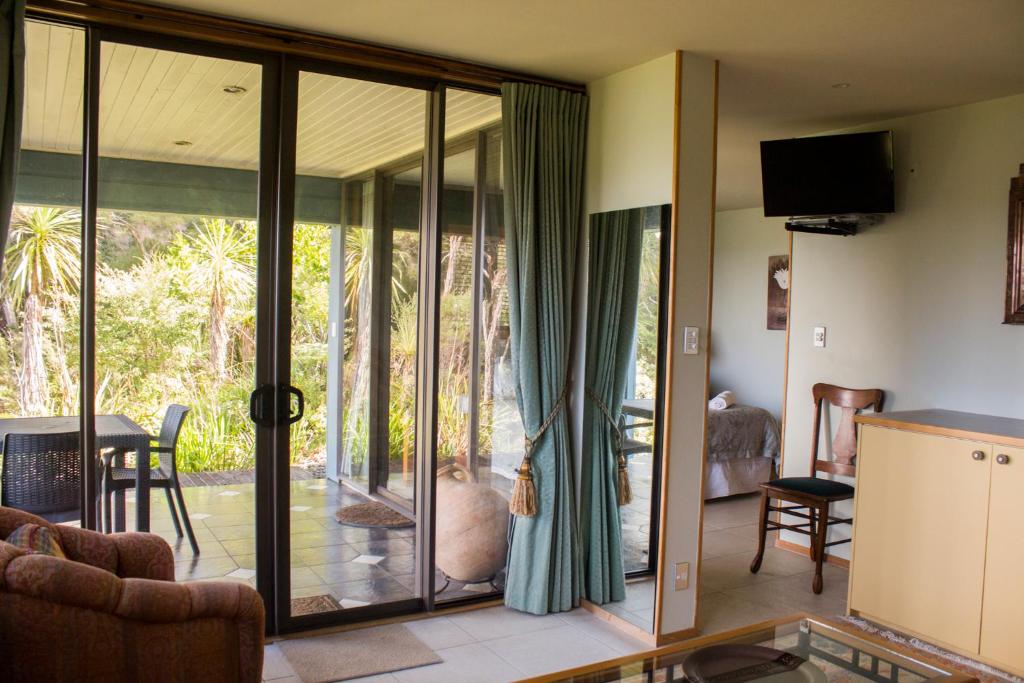 a living room with sliding glass doors to a patio at Titore Lodge in Russell