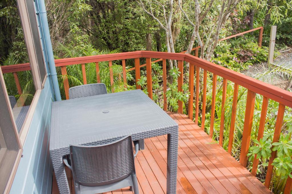 a table and chairs sitting on a deck at Titore Lodge in Russell