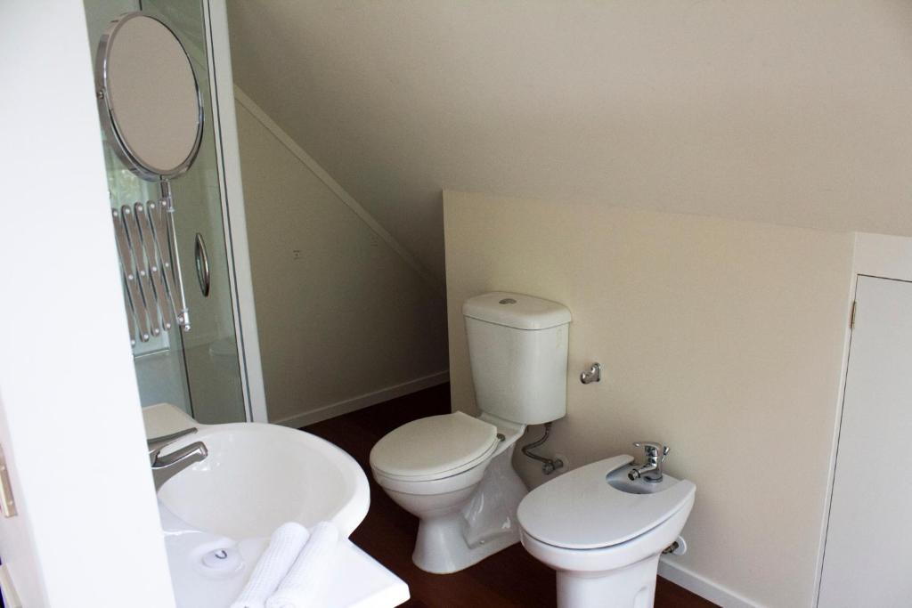 a bathroom with a toilet and a sink at Titore Lodge in Russell