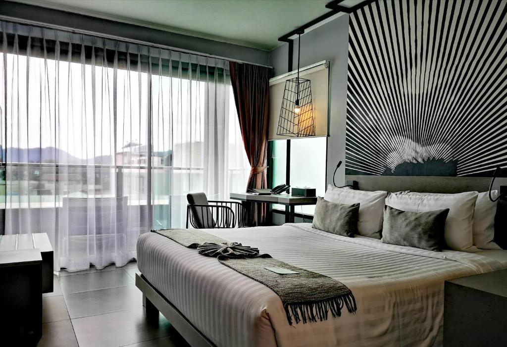 Postel nebo postele na pokoji v ubytování Mazi Design Hotel by Kalima