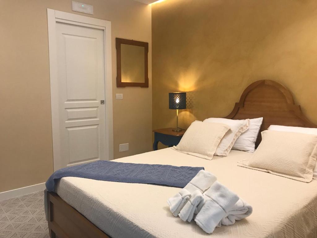 a bedroom with a bed with white towels on it at Estlevante B&B in Vieste