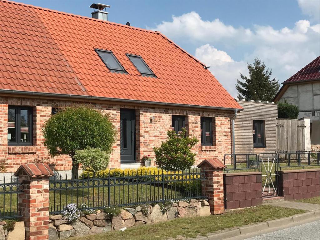 a brick house with an orange roof at FeWo No.18 in Dassow