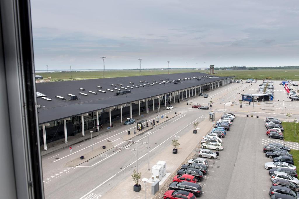 an airport parking lot with a bunch of parked cars at Aalborg Airport Hotel in Aalborg