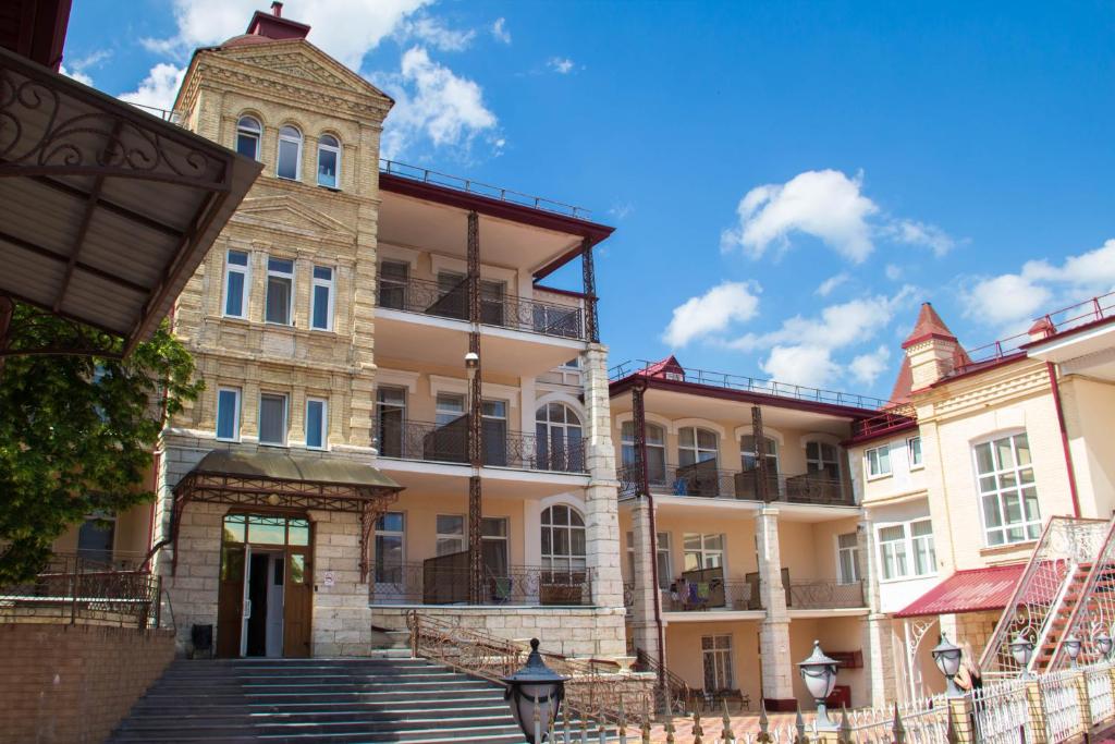 a building with a staircase in front of it at Pyatigorskaya Klinika Sanatorium in Pyatigorsk