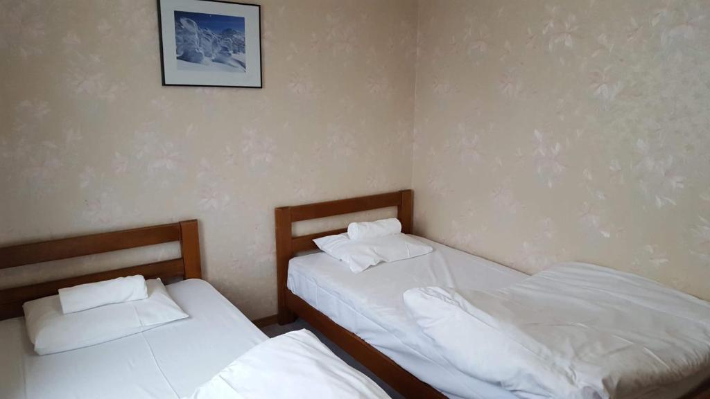 Postel nebo postele na pokoji v ubytování Absolute Niseko Lodge