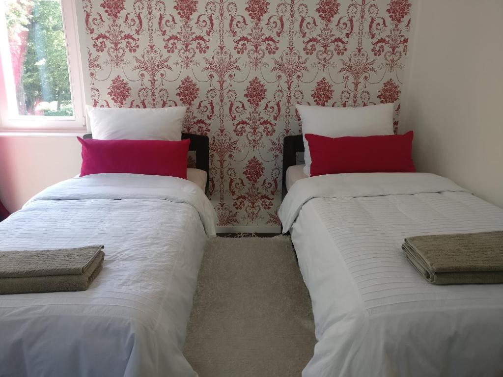 two beds sitting next to each other in a room at Villa Wilmarie in Rottweil