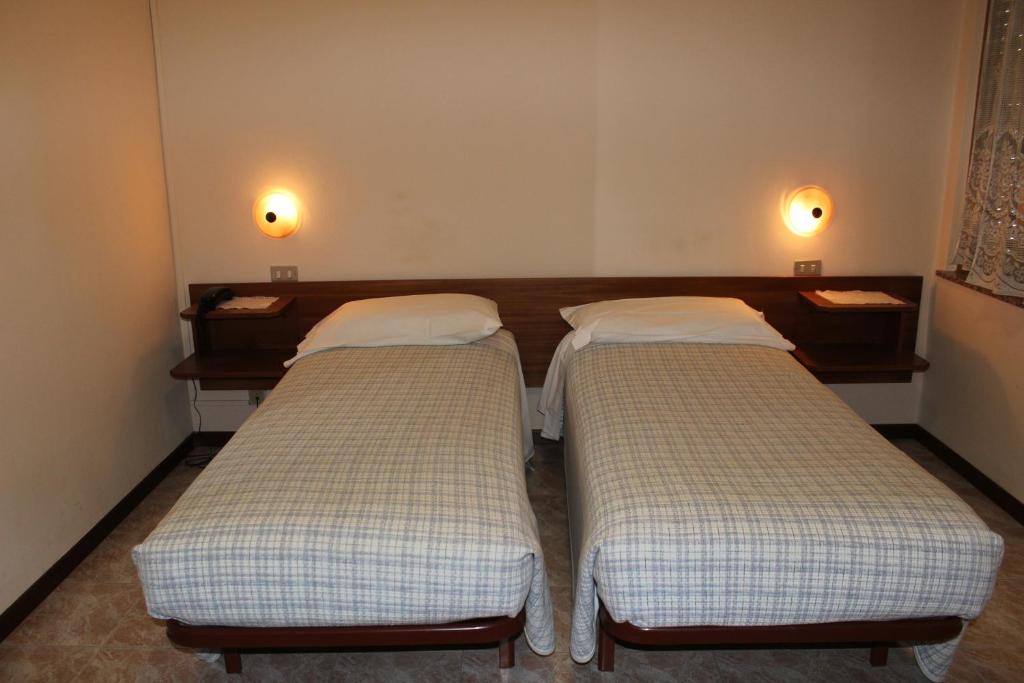 Postel nebo postele na pokoji v ubytování Albergo Napoleone