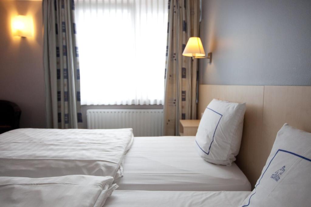 Rúm í herbergi á Hotel Empire