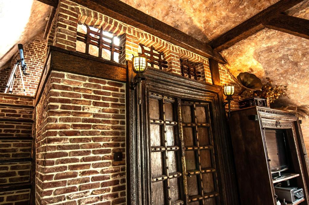 a room with a brick wall and a window at Attic Apartment Warszawa in Warsaw