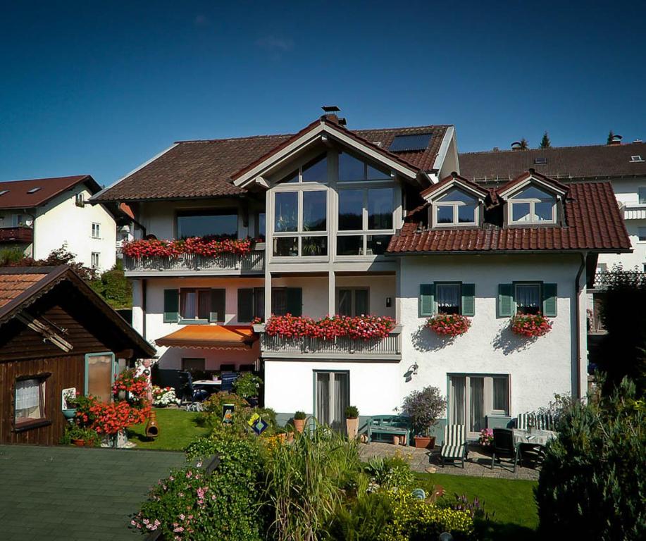 a large house with flower boxes on the balconies at Arber Ferienwohnungen Friedl in Bayerisch Eisenstein