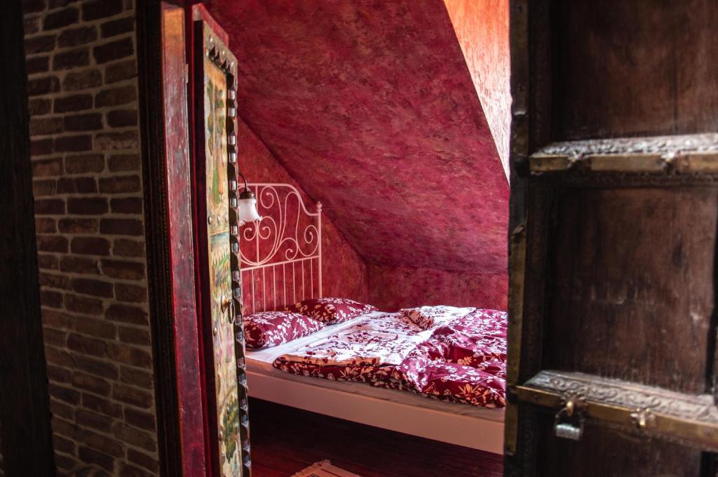 a bed in a room with a red ceiling at Attic Apartment Warszawa in Warsaw