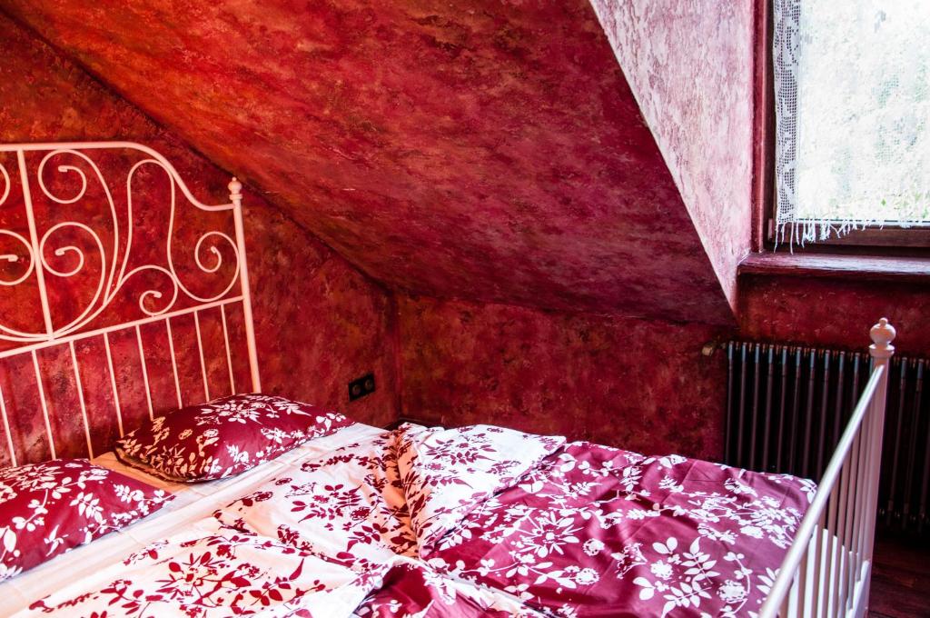a bedroom with a bed in a red room at Attic Apartment Warszawa in Warsaw