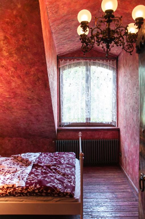 a bedroom with a bed and a window at Attic Apartment Warszawa in Warsaw