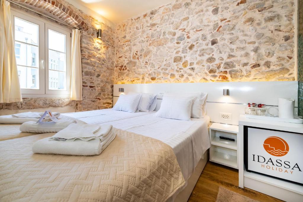 Postel nebo postele na pokoji v ubytování Idassa Palace rooms