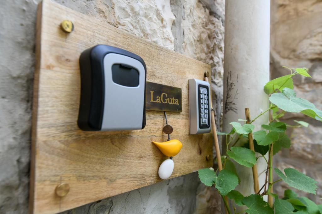 a switch with a cell phone on a wall at La Guta Studio Suite Jerusalem in Jerusalem