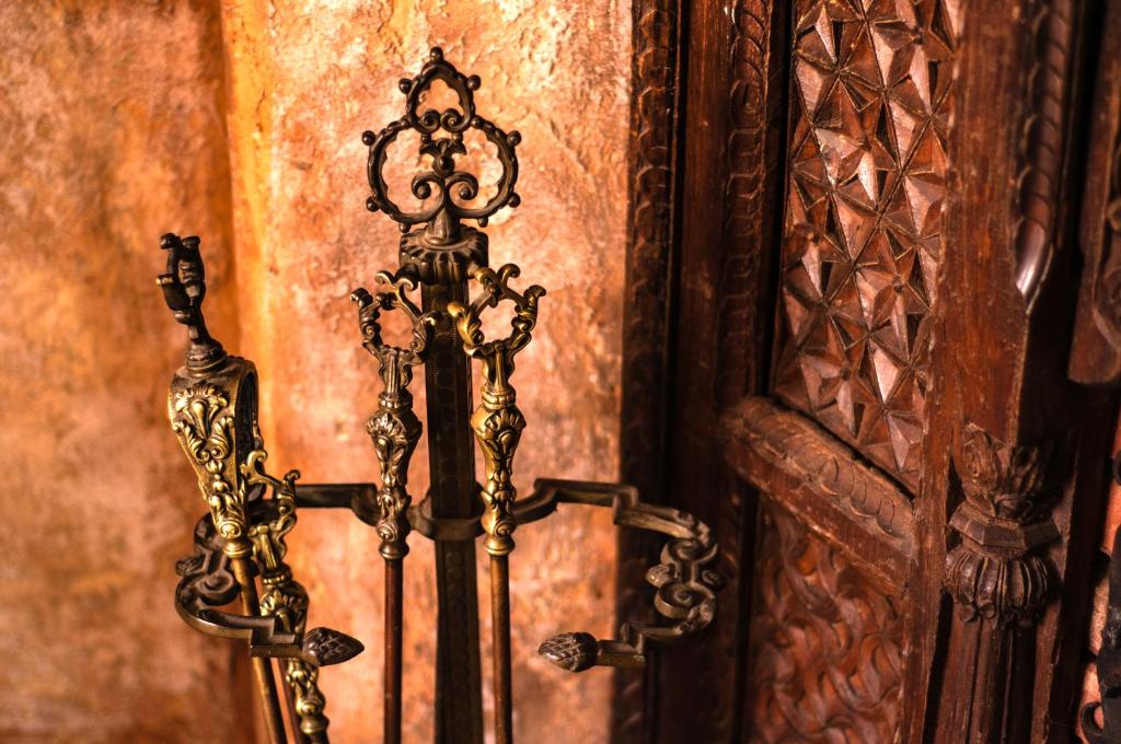a gold candlesticks in front of a wall at Attic Apartment Warszawa in Warsaw