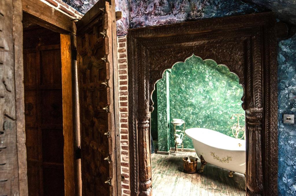 a bathroom with a bath tub and a mirror at Attic Apartment Warszawa in Warsaw