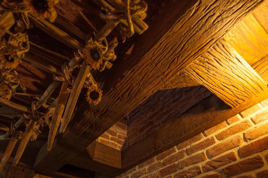 a wooden ceiling of a room with a brick wall at Attic Apartment Warszawa in Warsaw